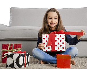 Image showing Little girl opening presents