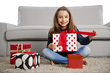 Image showing Little girl opening presents