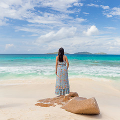 Image showing Woman enjoying Anse Patates picture perfect beach on La Digue Island, Seychelles.