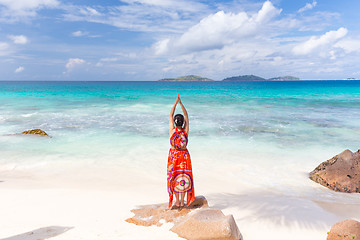 Image showing Woman enjoying Anse Patates picture perfect beach on La Digue Island, Seychelles.