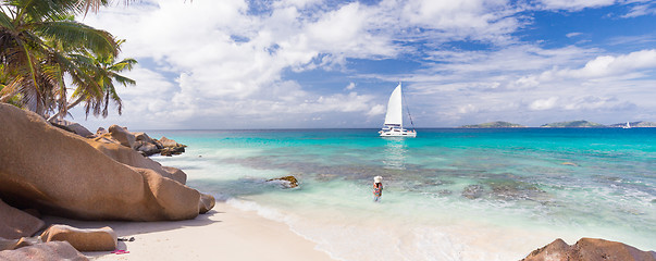 Image showing Woman enjoying Anse Patates picture perfect beach on La Digue Island, Seychelles.