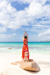 Image showing Woman enjoying Anse Patates picture perfect beach on La Digue Island, Seychelles.