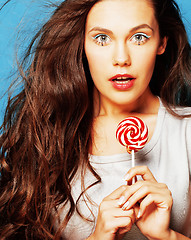 Image showing young pretty adorable woman with candy close up like doll