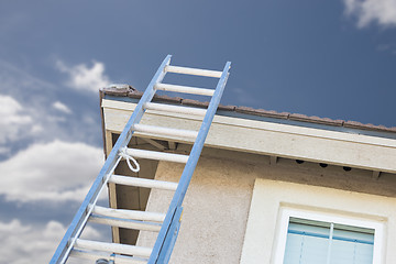 Image showing Construction Ladder Leaning Against House