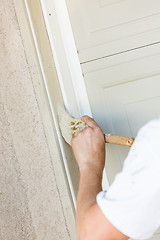 Image showing Professional Painter Cutting In With Brush to Paint Garage Door 