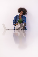 Image showing african american woman sitting on floor with laptop