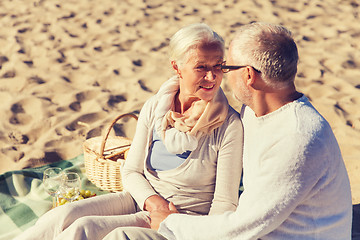 Image showing happy senior couple talking on summer beach