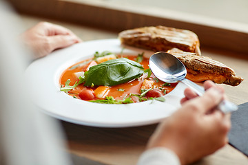 Image showing woman eating gazpacho soup at restaurant