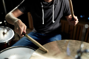 Image showing male musician playing drums and cymbals at concert