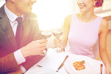 Image showing happy couple with glasses of wine at restaurant