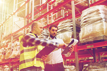 Image showing worker and businessmen with clipboard at warehouse