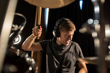 Image showing male musician playing drums and cymbals at concert