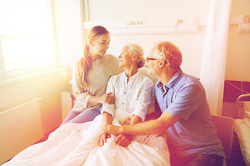 Image showing happy family visiting senior woman at hospital