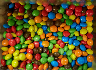 Image showing close up of multicolored dragee candies in box