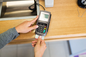 Image showing close up of hand inserting bank card to terminal