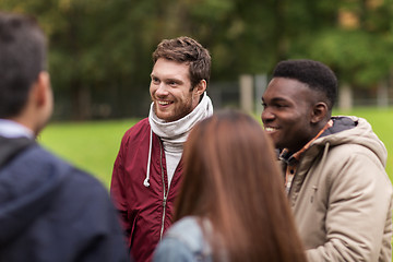 Image showing happy friends walking along autumn park