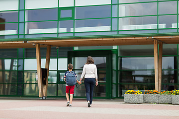 Image showing elementary student boy with mother going to school