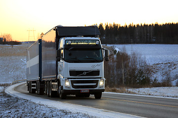 Image showing White Volvo FH Combination Vehicle on Winter Sunset Road