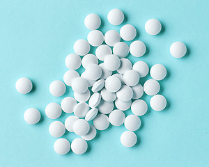 Image showing white pills on blue background