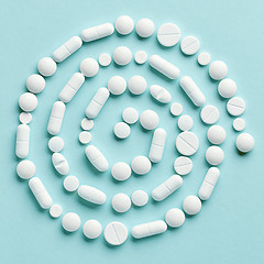 Image showing white medicine pills on blue background