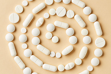Image showing white medicine pills on beige background
