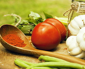 Image showing vegetables on wooden kitchen with spicies, tomato, chilli, green
