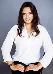 Image showing pretty brunette confident mature woman sitting on chair in studi