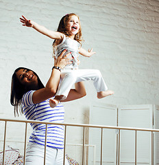 Image showing mother with daughter together in bed smiling, happy family close