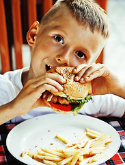 Image showing little cute boy 6 years old with hamburger and french fries maki