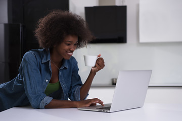 Image showing smiling black woman in modern kitchen