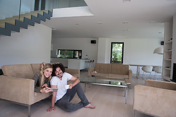 Image showing couple relaxing at  home with tablet computers