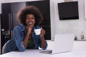 Image showing smiling black woman in modern kitchen