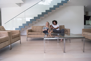 Image showing Young couple on the sofa watching television