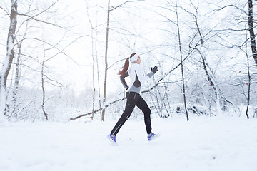 Image showing Brunette running in winter park