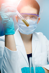 Image showing Young researcher with test tubes