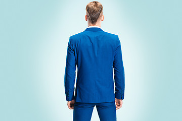 Image showing The young stylish man in a suit. Rear view from the back.