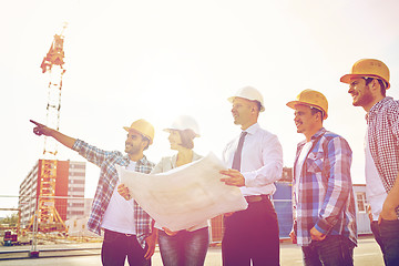 Image showing group of builders and architects with blueprint