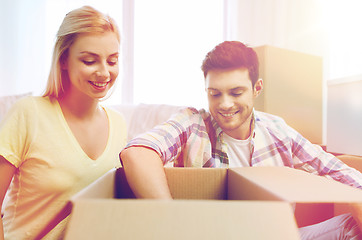 Image showing smiling couple with big boxes moving to new home