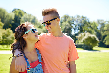 Image showing happy teenage couple looking at each other in park