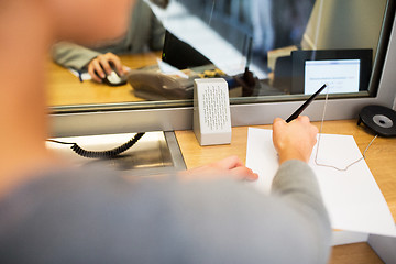 Image showing customer writing application at bank office