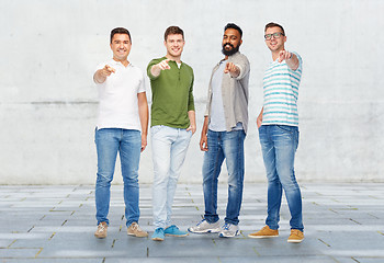 Image showing happy smiling men pointing finger to you