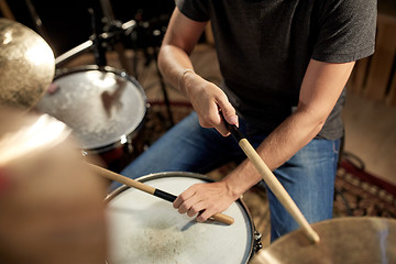 Image showing male musician playing drums and cymbals at concert