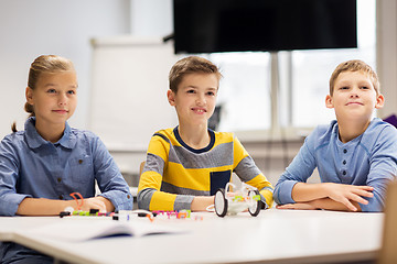 Image showing happy children building robots at robotics school