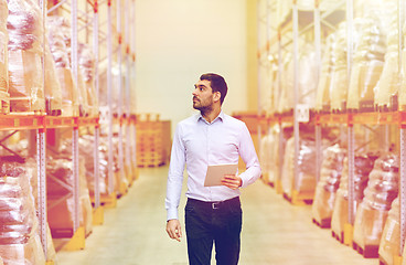 Image showing businessman with tablet pc at warehouse