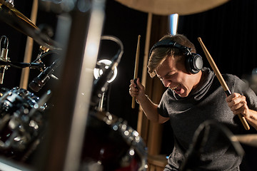 Image showing male musician playing drums and cymbals at concert