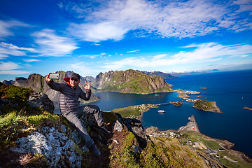 Image showing Man on top of a mountain taking a selfie