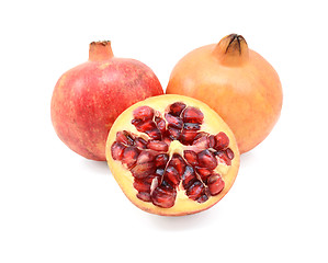 Image showing Two pomegranates and a cut half showing seeds