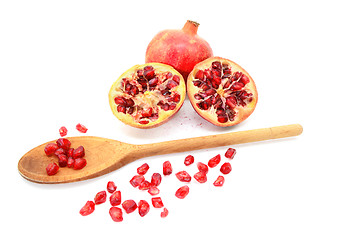 Image showing Pomegranate and two cut halves with seeds removed with spoon