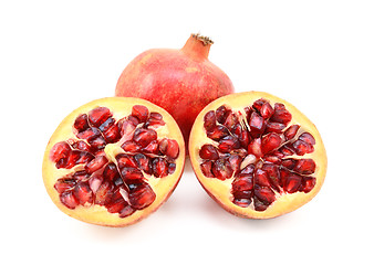 Image showing Whole red pomegranate and two cut halves showing seeds