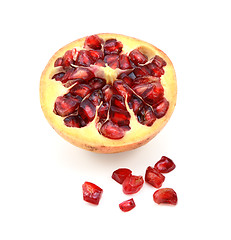 Image showing Cut half pomegranate with seeds removed